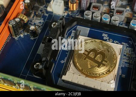 Bitcoins on the motherboard. Crypto currency Gold Bitcoin - BTC - Bit Coin Stock Photo