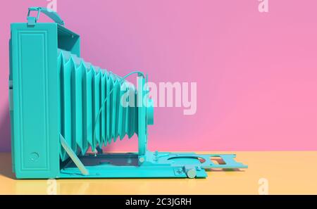 Old retro camera in monochrome turquoise color isolated on pink and yellow background. Creative conceptual illustration in cartoon style with copy spa Stock Photo