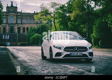 MUNICH, GERMANY - May 03, 2020: Modern sporty car from Mercedes benz drives in front of old architecture in Munich. Stunning luxury car on a spring mo Stock Photo