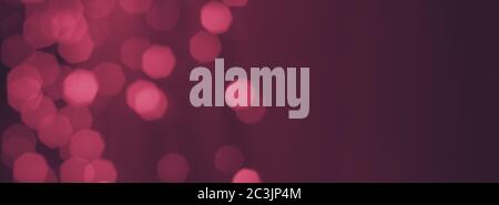 dark mauve background with blurry pink bokeh lights, wide banner backdrop Stock Photo