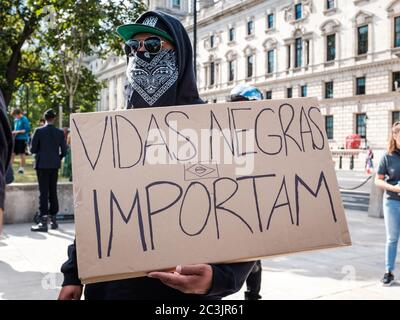 London, UK. 20th June, 2020. A protestor holds a sign which says ‘Vidas Negras Importam’ which means Black Lives Matter in Portuguese during the Black Lives Matter protest in London. Credit: Yousef Al Nasser/ Alamy Live News Stock Photo