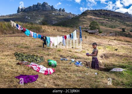 African girl washing clothes Central Madagascar . Andringitra national park Stock Photo