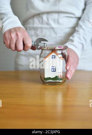 small house inside a glass jar Stock Photo