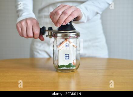 small house inside a glass jar Stock Photo