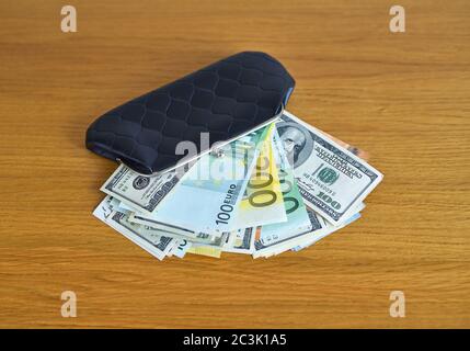 Euro and dollars money with black wallet on the table Stock Photo