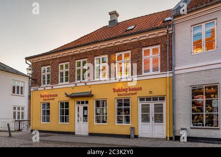 chinese restaurant in a yellow house on an empty street in the old town of Ribe, Denmark, May 29,2020 Stock Photo