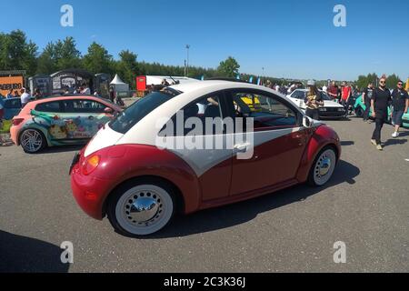 Moscow, Russia - June 01, 2019: Tuned red and white volkswagen beetle parked on the street, Scirocco wrapped stays at background Stock Photo