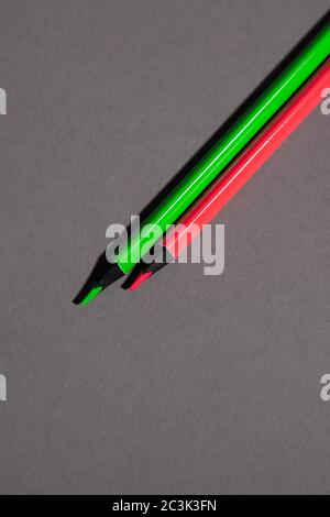 green and red pencil on gray background Stock Photo
