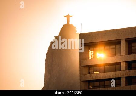 Sun is shining through the window of office building and Corcovado mountain is behind it Stock Photo