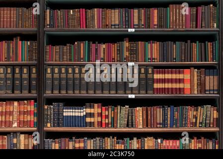 Antique Books on Old Wooden Shelves Stock Photo