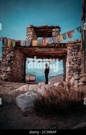 Vertical shot of a man in the Nako village, Spiti Valley at the entrance of a holy gate Stock Photo
