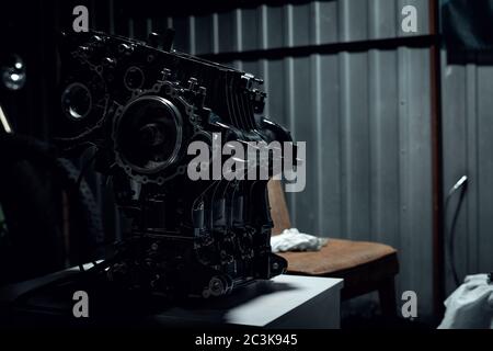 Assembled fast motorcycle engine stands on the table ready to mount on the motorcycle. Stock Photo