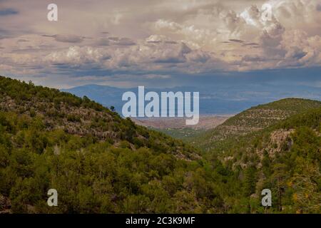 View from the Sandia Man Cave looking towards Placitas, outside of Albuquerque, New Mexico showing the green forest in the Sandia Mountains Stock Photo