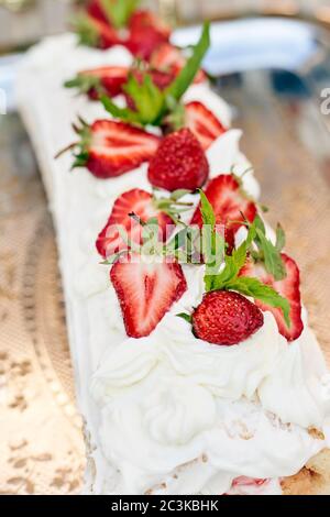Freshly baked sweet strawberry Long-Cake Roll, also called Strawberry roulade