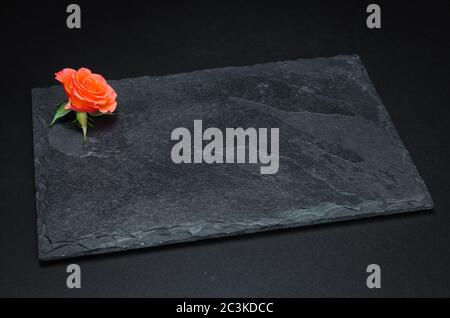 Empty slate plate on black background for use in culinary photos. Stock Photo