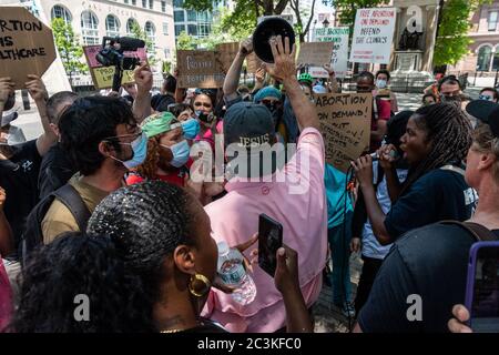 A coalition of pro-choice and civil rights groups protest the event 'Jesus Matters,' organized by two anti-abortion hate groups, Love Life and Operation America, and headlined by far-right minister Flip Benham (pink shirt), who was featured in the documentary 'AKA Jane Roe', in Cooper Triangle in New York City on June 20, 2020. (Photo by Gabriele Holtermann/Sipa USA) Credit: Sipa USA/Alamy Live News Stock Photo