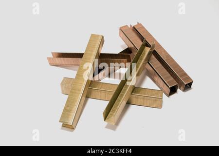 Closeup shot of stapler pins under the lights isolated on a white background Stock Photo
