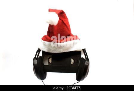 Headphones with a tape in the middle of it with a small Christmas hat on it Stock Photo