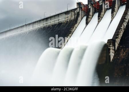 Water spilling over the dam Stock Photo