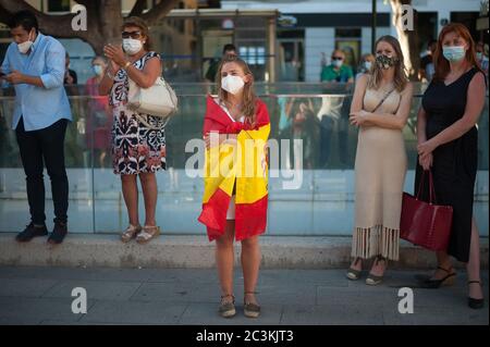 Malaga, Spain. 20th June, 2020. A woman wrapped with a Spanish flag takes part during a protest in favor of bullfighting.Supporters of bullfighting demand more grant and public resources for their sector after massive events were cancelled due to the coronavirus outbreak in Spain. Credit: SOPA Images Limited/Alamy Live News Stock Photo