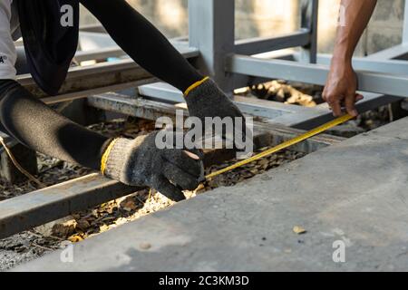 Workers are measuring the floor of toilet before construct and process next step Stock Photo