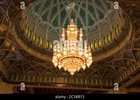 Muscat, Oman - February 28, 2016: The chandelier and inside of the dome of Sultan Qaboos Grand Mosque in Muscat, Oman. This is the largest and most de Stock Photo