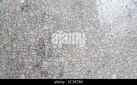 A crack pattern in the glaze of a ceramic plate., close up Stock Photo