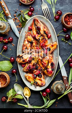 Fried chicken wings in spicy cherry sauce.Grilled chicken, fast food. Stock Photo