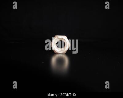 Metal nut or bolt isolated on black background. Stock Photo