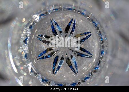 Sparkling defocused lead crystal glass texture background with starburst design Stock Photo