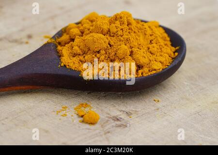 Turmeric powder herb on wooden background. Stock Photo