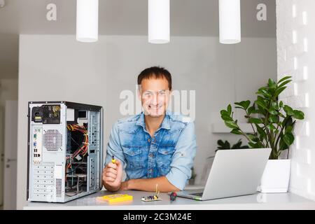 Computer engineer working on broken console in his office Stock Photo