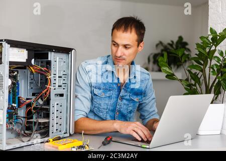Computer engineer working on broken console in his office Stock Photo