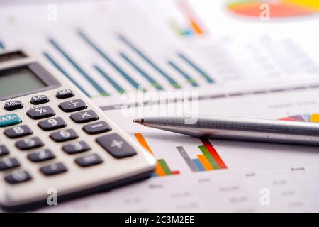 Calculator and pen on charts and graphs spreadsheet paper. Finance, Account, Statistics, Analytic research data and Business company meeting concept Stock Photo