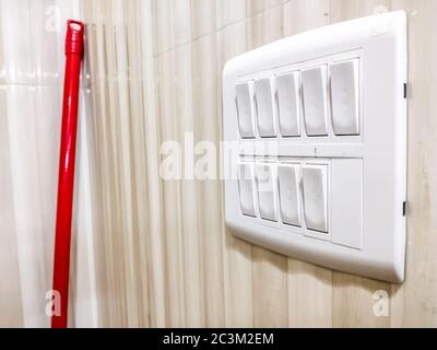 White Light switch on switchboard - Light brown background Stock Photo