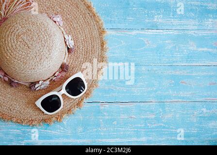 Fashion hat and eyeglasses for travel on blue wooden background : New year Festival concept. Stock Photo