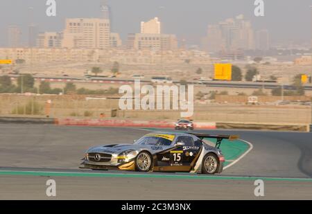 DUBAI - JANUARY 14: Car 15, a Mercedes SLS AMG GT3 with Dubai City in the background, during the 2012 Dunlop 24 Hour Race at Dubai Autodrome on Januar Stock Photo