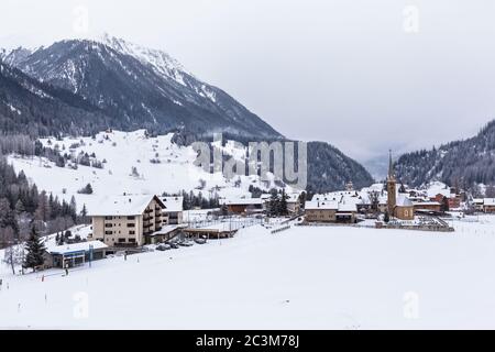 Beautiful view of the small town Bergun and the alps including Piz Ela from the sightseeing train Glacier Express in winter Canton of Grisons, Switzer Stock Photo