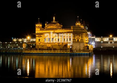 Beautiful shot of the Harmandir Sahib's building on a reflective lake foreground in India Stock Photo