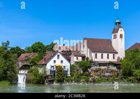 Peaceful view of a small church on the riverside of Rhine on a sunny day, on the border between Germany and Switzerland near Basel. Stock Photo