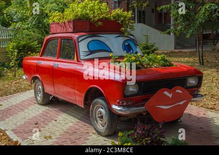 Goryachy Klyuch, Russia– September 07, 2015:  Flowerbed inside red car in Goryachy Klyuch, balneological resort in Krasnodar Krai, Russia Stock Photo