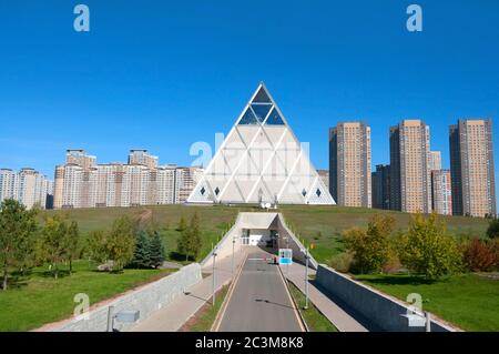 The Palace of Peace and Reconciliation (Pyramid of Peace and Accord) in the green Presidential Park in Astana, Kazakhstan Stock Photo