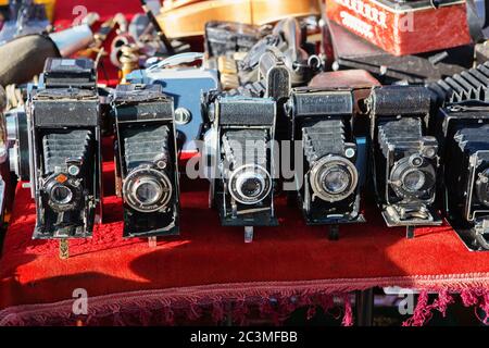 SOFIA, BULGARIA - April 2018: Old vintage photo cameras selling in the antiquities market. Vintage cameras and other goods on the street flea market. Stock Photo