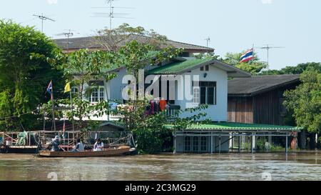 AYUTTAYA, THAILAND - OCTOBER 5: The Chao Praya River running through a residential area during the monsoon season in Ayuttaya, Thailand on October 5,