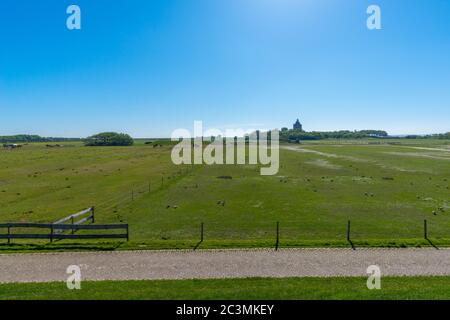 Meadows and the 'Turmwurt' with the famous lighthouse, North Sea island of Neuwerk, Federal State Hamburg, Germany, Europe, UNESCO World heritage, Stock Photo