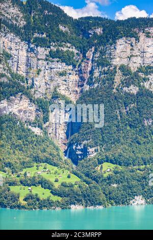 Beautiful  view of the Seerenbachfall waterfall on the cliff,  on the lake side of Walensee (Walen) lake, Canton of Glarus, Switzerland. Stock Photo