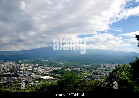 View towards cloud covered mount Fuji over Kawaguchi town, Japan Stock Photo