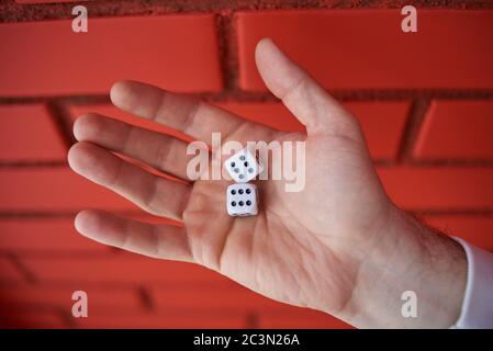 the dice in his hand. combination of 6 and 6 Stock Photo