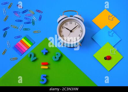 Colorful stationery on a blue monophonic background. Numbers and add-ons. teaching children math Mockup, space for text. Education. Stock Photo