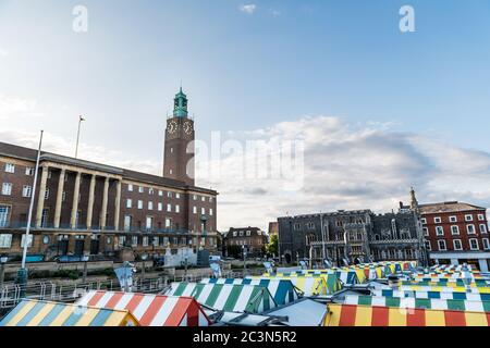 Wide-angle view of the colourful rooftops on Norwich Market, with the medieval Guildhall in the background, a historic construction originally built t Stock Photo